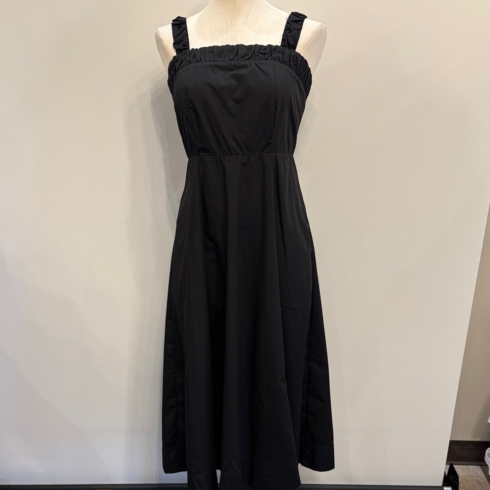 Black dress. Cinches in the back with buttons. Straps tighten with bow in back.